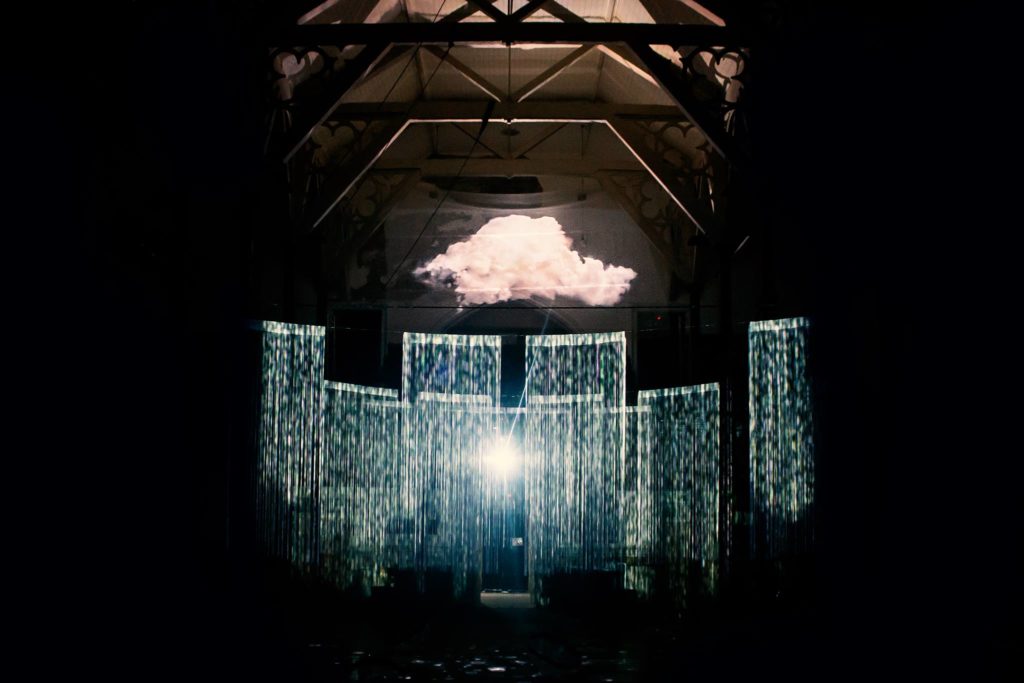 Lighting installation with a cloud and sheets of rain/light